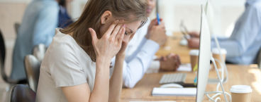 senhora com sinais de stress durante o trabalho