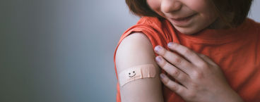 mulher com penso rápido no braço após vacinação