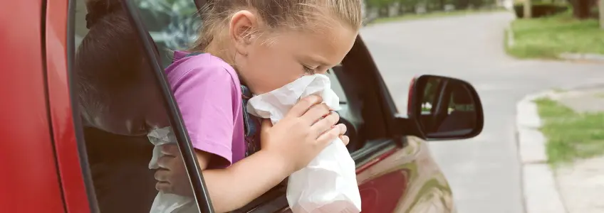 menina a sentir-se enjoada numa viagem de carro